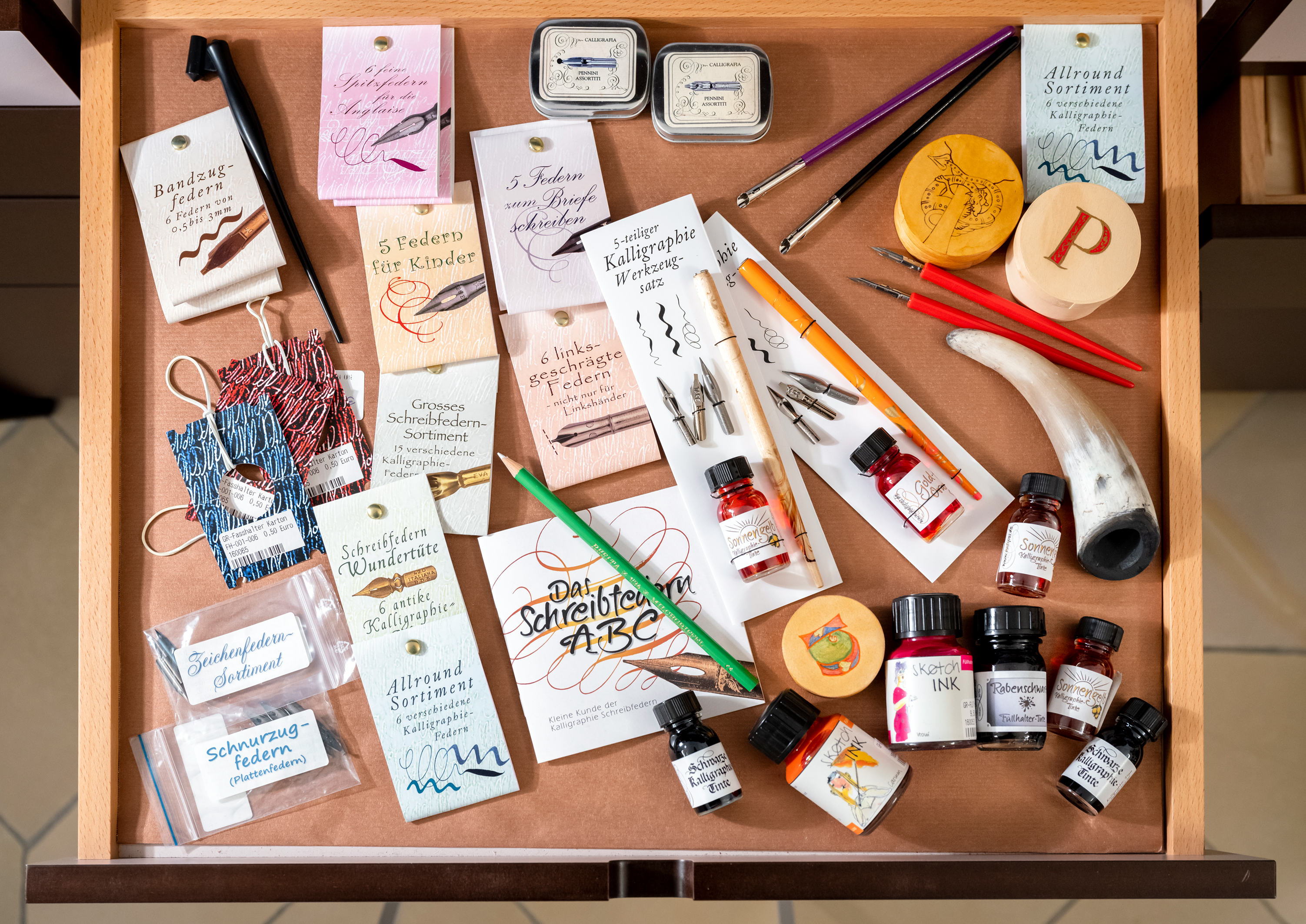 Tinten, Federn und anderes Kalligrafiezubehör in einer Schublade im Klosterladen Seeon